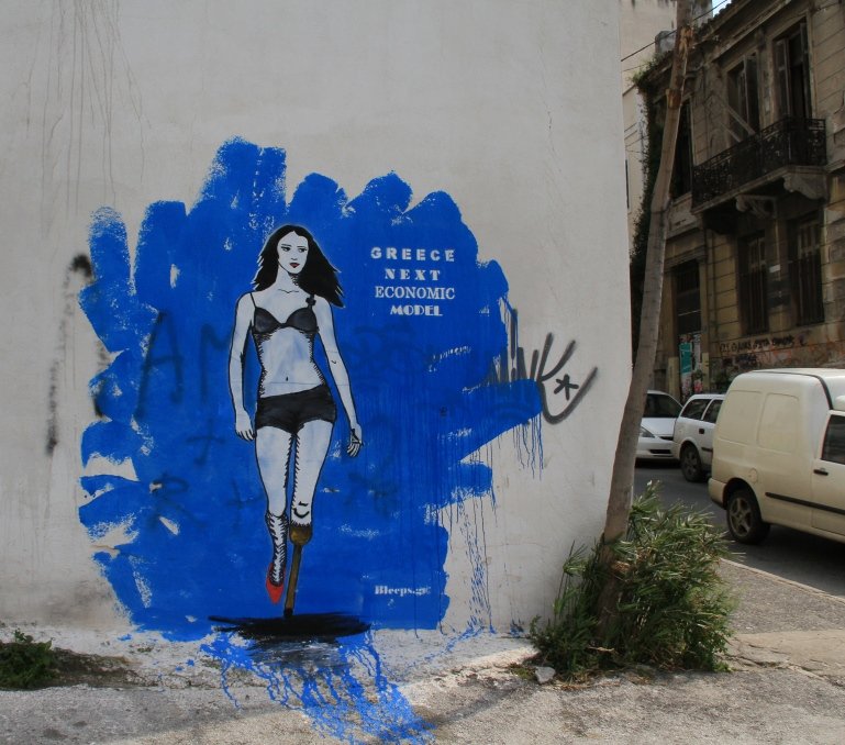 Graffiti politique sur le mur d'une rue centrale d'Athènes (Villiam Curtis).